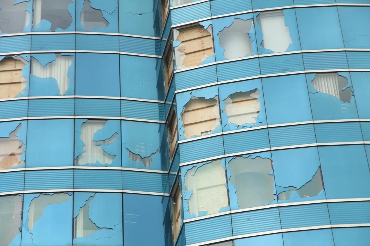 Close view showing broken and displaced façade panels